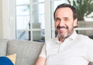 male smiling at home after successful mental health treatment programs 
