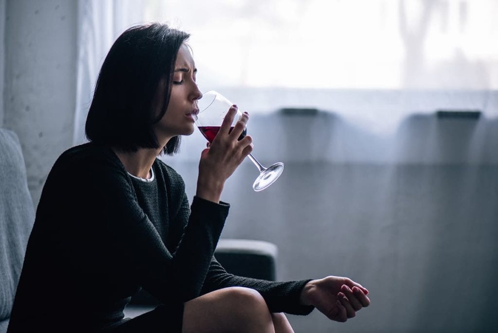 woman drinking thinks is alcoholism a disease? Alcoholism is a disease. Get alcohol addiction treatment today.