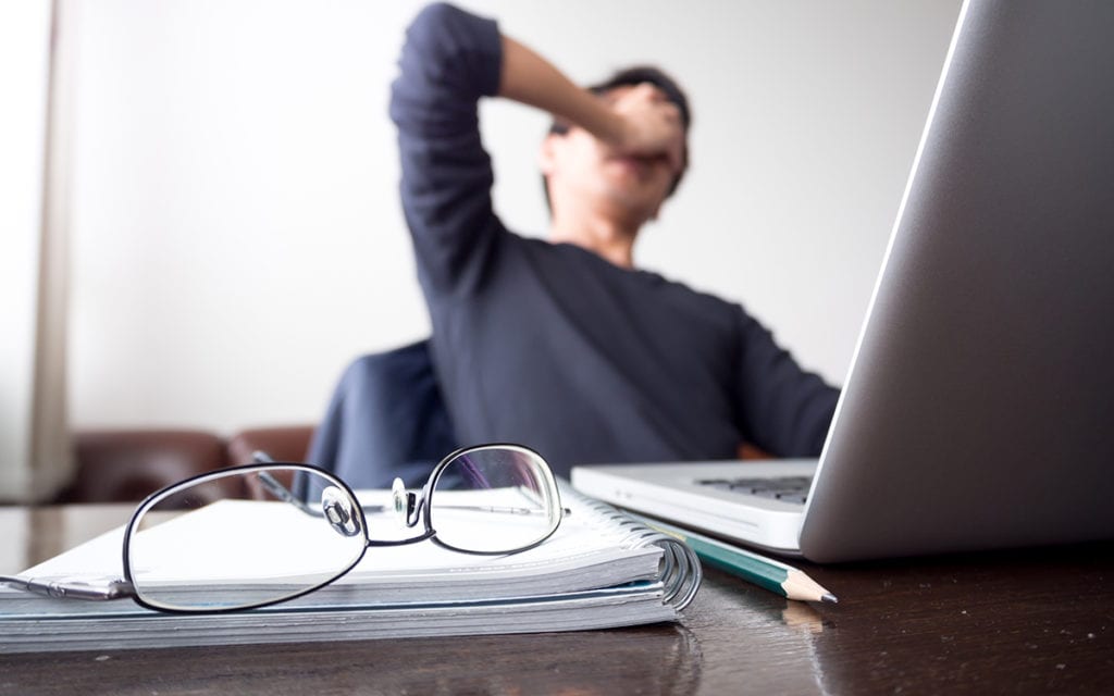 Signs of Anxiety, man with his hand holding his face working