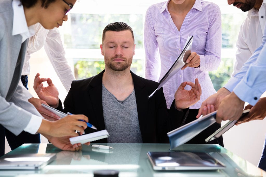 stress management techniques, Young Businessman Meditating In Office