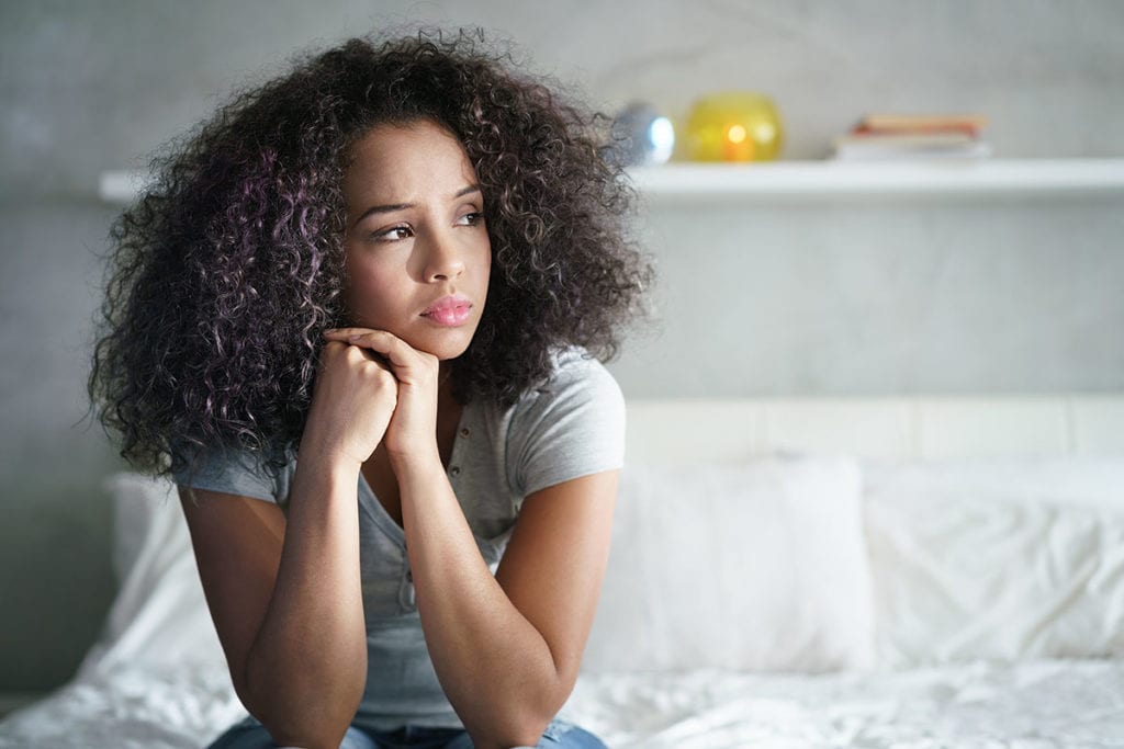 pensive woman worrying about risk factors for addiction