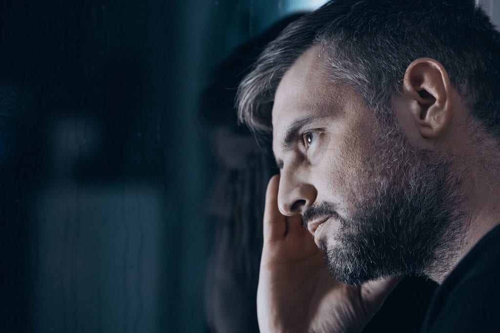 pensive man staring thinking about the types of addiction