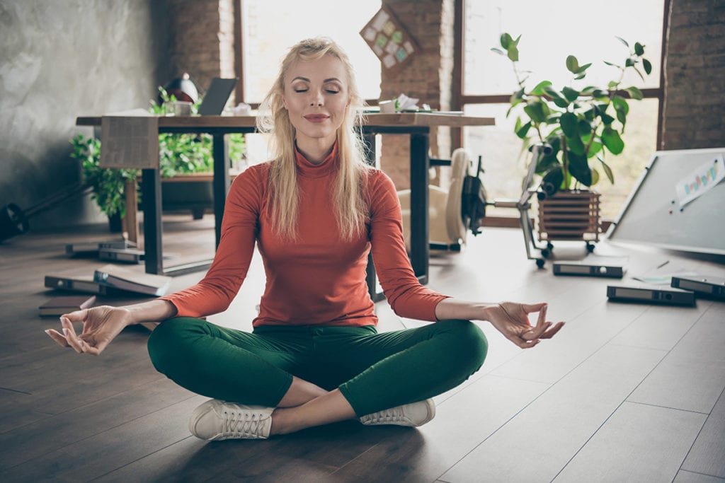 woman meditating with crossed legs knows how to prevent a panic attack