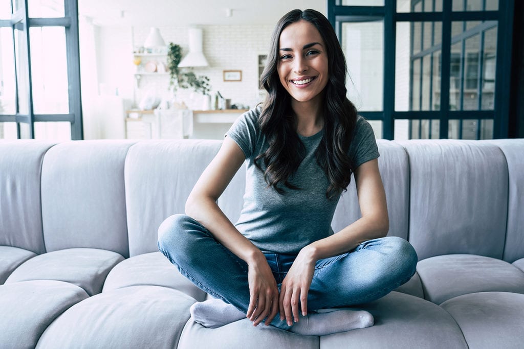 woman sitting on couch Staying sober during Coronavirus