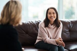 Two people talking at a drug rehab program