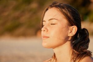Person outdoors in the sunlight thinking about ecstasy abuse rehab