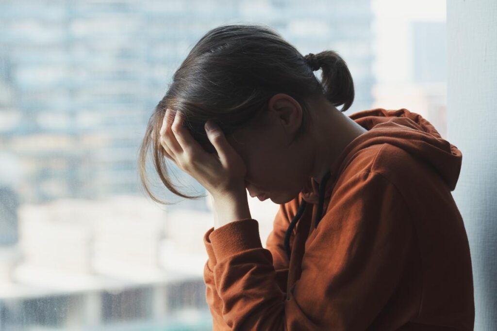 Person next to window, thinking about what the long term effects are of Rohypnol abuse