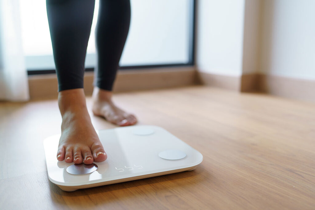 Feet of person seeing weight gain after quitting alcohol
