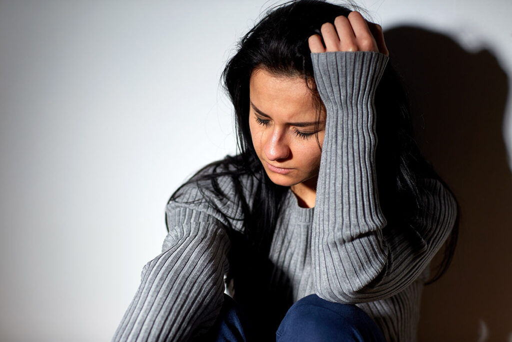 Person thinking about how women and alcoholism are connected