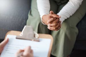 Hands of people in a cognitive-behavioral therapy session